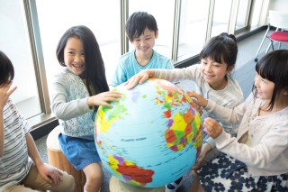 student learning the globe at international school